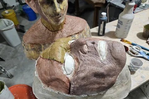 Monster masks being sculpted and painted for a shoot