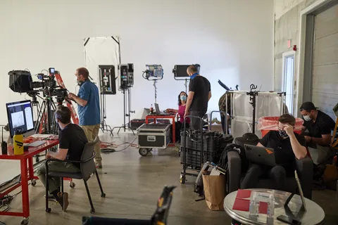 Cameras, lights and crew in a big studio