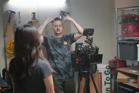 Brian directing an actor in a garage set