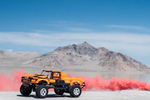A LEGO truck and red smoke on the salt flats