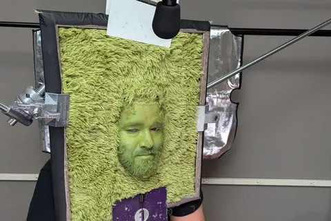 An actor’s face through a shag rug, rigged for a SmartStop shot